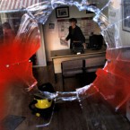 A woman clears debris from the office of Ireland's Minister for Transport Noel Dempsey TD of the Fianna Fail party that was vandalized and painted with the words 'traitors' in Trim, Nov. 23, 2010. 

(AP Photo/Peter Morrison)