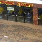A man watches as water flows past in Toowoomba, Australia, during a flash flood 10 January, 2011. (AP Photo/ABC)