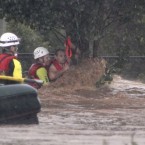 A man is rescued by emergency workers after he was stranded clinging to a tree on a flooded street in Toowoomba, Australia, during a flash flood Monday, on 10 January, 2011. (AP Photo/ABC) 