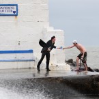 Fine Gael candidate Eoghan Murphy hands a pamphlet to a worker from his campaign office on the Great South Wall in Dublin.