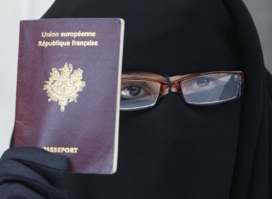 French woman Najat shows her European passport, as dressed in a niqab.