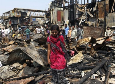 Slumdog Millionaire star Rubina Ali walks through the debris of her home in Mumbai, which was among 500 destroyed by fire on Friday night.
