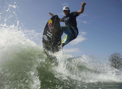 Panama's surfing champion Gary Saavedra rides a wave created by a wakesurfing boat during a training session at the Chagres river on Monday.