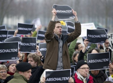 Anti-nuclear demonstrators in Berlin today bear signs saying