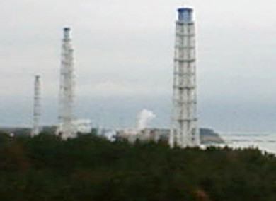 Smoke is seen emerging from one of the damaged reactor buildings at the Fukushima I power plant.