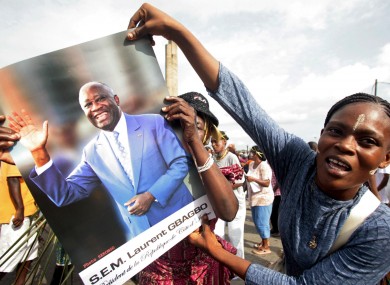 A woman shows her support to incumbent Ivory Coast President Laurent Gbagbo during a rally in Abidjan