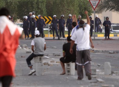 Anti-government protesters gesture towards riot police in Bahrain last month.