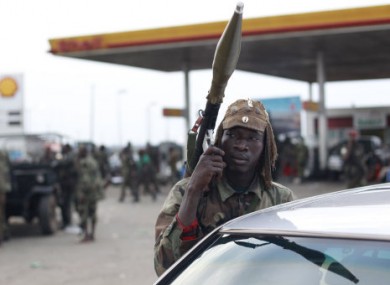 Soldiers loyal to Alassane Ouattara rest at a gas station in the Youpougon neighborhood, at the main northern entrance to Abidjan, Ivory Coast, Tuesday, April 5