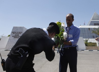 An Egyptian policemean checks flowers to be delivered to former President Hosni Mubarak from an Egyptian citizen earlier this week.