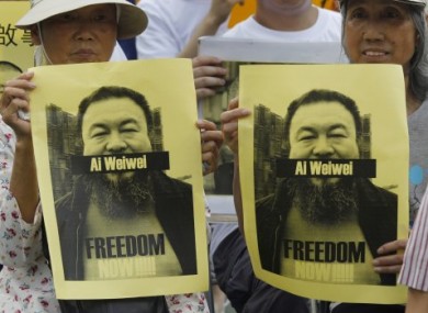 Pro-democracy protesters hold photos of detained Chinese artist Ai Weiwei at a demonstration in Hong Kong on 2 May.