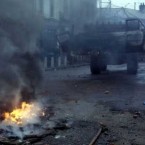 The British army removes burnt cars from the Falls Road in Belfast on the eve of Bobby Sands' funeral, 1981. Pic: Photocall Ireland