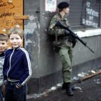 Local boys pose for the camera as a British soldier surveys the Falls Road in Belfast on the eve of Bobby Sands' funeral. Pic: Photocall Ireland