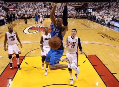 Dallas Mavericks' Shawn Marion lands a big dunk during the first half.