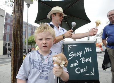 A boy eats an ice cream at the protests against Ireland's austerity programme in Dublin today.