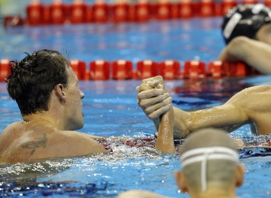 Lochte is congratulated by a disappointed Phelps