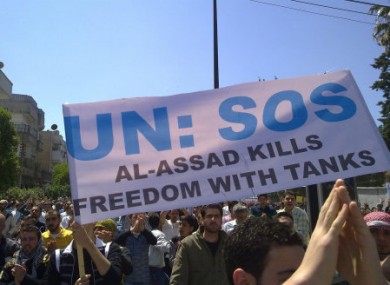 File photo of a protest poster appealing for UN intervention in the Syrian city of Homs.