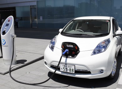 Nissan's chief engineer Hidetoshi Kadota demonstrates how a Nissan Leaf electric car is recharged. The manufacturer has accused Top Gear of deliberately trying to make its car run out of power.