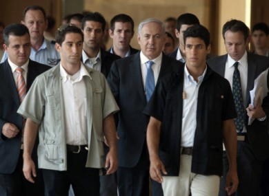 Israeli Prime Minister Benhamin Netanyahu, centre, photographed yesterday with his bodyguards.
