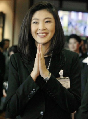 Prime Minister Yingluck Shinawatra gives a Thai traditional