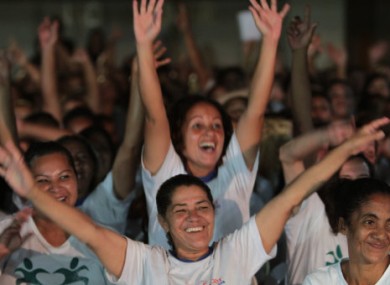 Inmates celebrate as the winner is announced yesterday.
