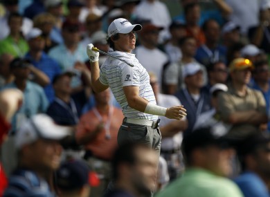 McIlroy hits a drive on the 15th hole.