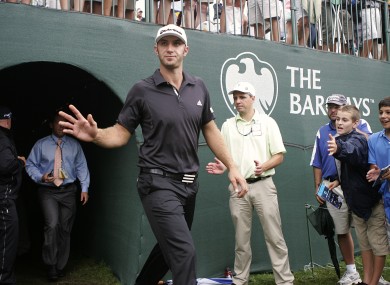 Dustin Johnson emerges back onto the 18th green after signing his score card on Sunday.