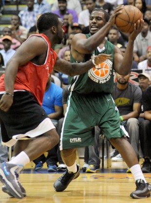 Chris Paul, right, of the New Orleans Hornets, plays against former NBA player Ty Lawson.