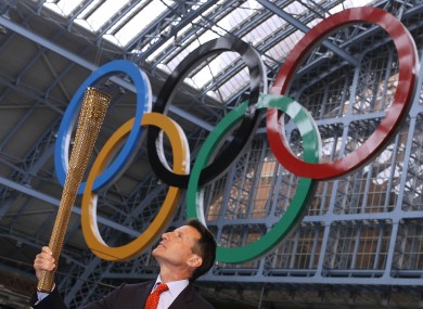 Olympics committee chairman Sebastian Coe holds the torch