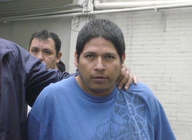 Jorge Antonio Iniestra is led away by police after his arrested on Tuesday.
