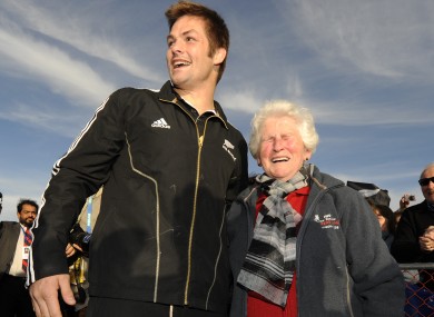 All Blacks captain Richie McCaw poses for a photograph with 73-year-old old Trish Conner in Christchurch