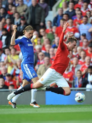 United's Phil Jones fall foul of Fernando Torres.