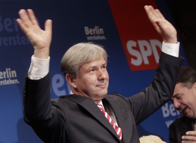 The SPD's Klaus Wowereit waves to party faithful after securing a third term as mayor of Berlin yesterday.