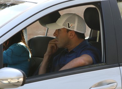 Tevez being driven away from his home yesterday.