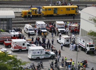 Emergency medical personnel wait for the evacuation of passengers involved in the collision.