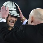 Richie McCaw is presented with a cap to honour his 100th test as an All Black.
(AP Photo/Ross Land)