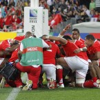 Tongan players embrace in prayer after beating France in Wellington.
(Christophe Ena/AP/Press Association Images)