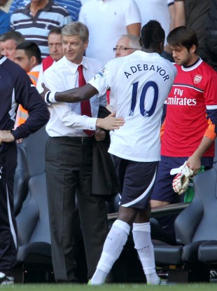 Arsenal manager Arsene Wenger shakes hands with his former striker at half time in yesterday's North London derby. Tottenham won the match 2-1.