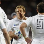 Jonny Wilkinson confers with his team-mates.
(AP Photo/Christophe Ena)