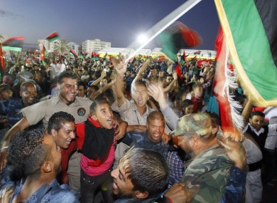 Libyans celebrate at Saha Kish Square in Benghazi, after the National Transitional Council declared the country's liberation from the rule of Muammar Gaddafi.
