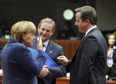 Enda Kenny speaks with Angela Merkel and UK PM David Cameron at last night's talks