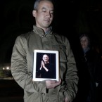 Conrad Corpus holds up an iPad with a photo of Steve Jobs on it at an iPhone vigil at Dolores Park in San Francisco. (AP Photo/Jeff Chiu)