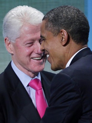 Former US President Bill Clinton and President Barack Obama embrace at the Clinton Global Initiative, Wednesday, Sept. 21, 2011, in New York