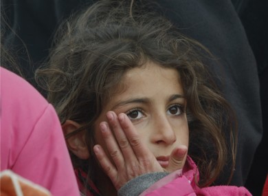 A survivor girl waits in line for food in the city of Van, following a devastating earthquake two weeks ago