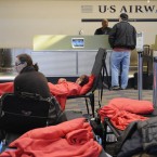 Stranded passengers rest on cots a day after a storm at Bradley International Airport in Connecticut (AP Photo/Jessica Hill)