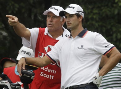 Adam Scott of Australia, right, listens to Steve Williams on the second tee during the third round in Shanghai.