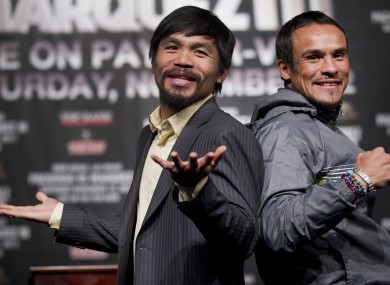 Manny Pacquiao, left, jokes with members of the media while posing for photos with Juan Manuel Marquez this week.