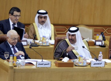 Qatari Foreign Minister Hamad bin Jasim, center, looks at Arab League secretary-general Nabil al-Arabi Nabil, left, during today's emergency meeting.