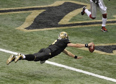 New Orleans Saints quarterback Drew Brees dives into the endzone to score a touchdown against the New York Giants last night. The Saints won the game 49-24.
