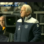 Eight minutes into the game, TV cameras showed Conor standing behind Giovanni Trapattoni - causing a flurry of texts from home. Image: RTÉ screen grab