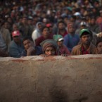 Men from Bangladesh, who used to work in Libya and fled the unrest in the country, wait to be called during their repatriation process as they try to leave for their country from a refugee camp at the Tunisia-Libyan border, in Ras Ajdir, Tunisia, on 14 March, 2011. (AP Photo/Emilio Morenatti/PA Images)